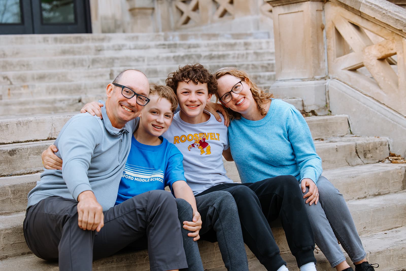 Kilibarda family sitting on steps together smiling